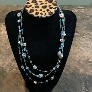 Costume jewelry. Necklace with light blue beads with little flowers